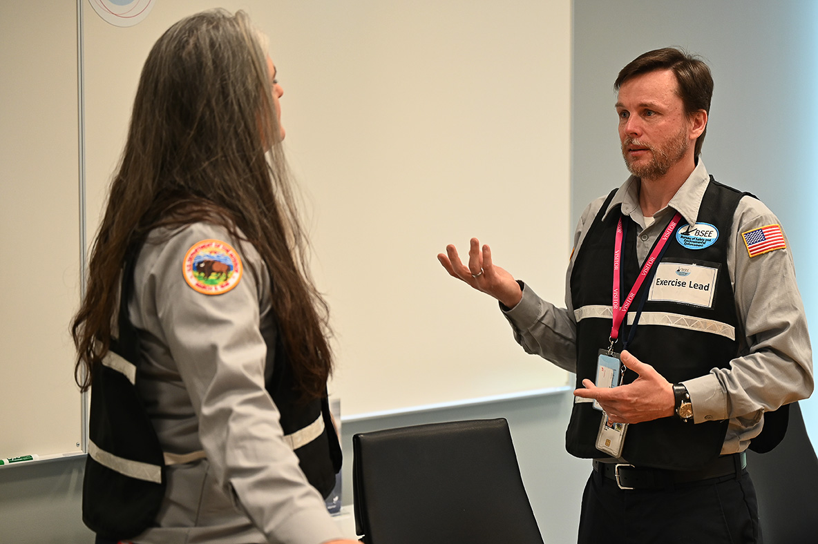 Sara Moore, left, Supervisor of the Gulf Regional Office of Safety Preparedness Division for the Bureau of Safety and Environmental Enforcement, and John Calvin, a BSEE senior preparedness analyst, discuss exercise scenarios during a government initiated unannounced exercise with Equinor Tuesday, May 24, 2022, in Houston, Texas. A GIUE is a preparedness verification function BSEE employs to witness and evaluate, on a no-notice basis, a plan holder’s capabilities to respond to a hypothetical oil spill.