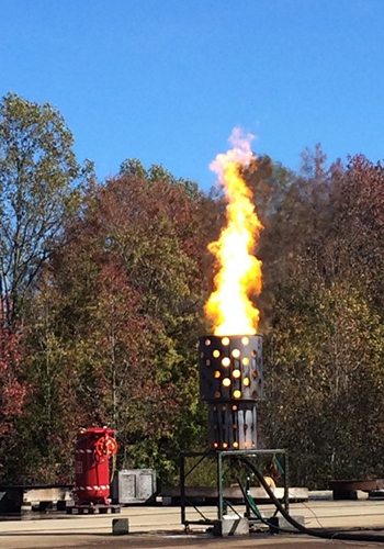 The low-emissions combustion unit “BSEE Burner” reduces emissions when burning crude and crude emulsions. Note absence of typical black smoke plume. (BSEE project 1106)