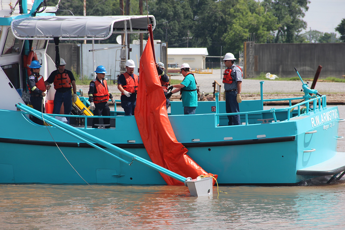 Oil spill removal organization personnel prepare to deploy an oil spill containment boom during an industry training session in the Gulf of Mexico.