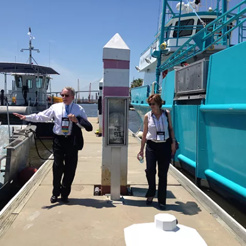 Deputy Director Margaret Schneider and Oil Spill Response Chief David Moore view on-water assets prior to their deployment during the demonstration at the International Oil Spill Conference. Deputy Director Margaret Schneider and Oil Spill Response Chief David Moore view on-water assets prior to their deployment during the demonstration at the International Oil Spill Conference.