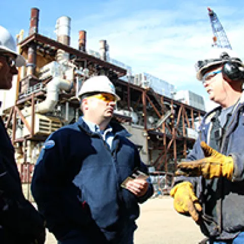 Michael Jordan (center) and Randy Howell (left) speak with Hilcorp Alaska, LLC foreman Lance Kulhavy during an inspection at Northstar Island.