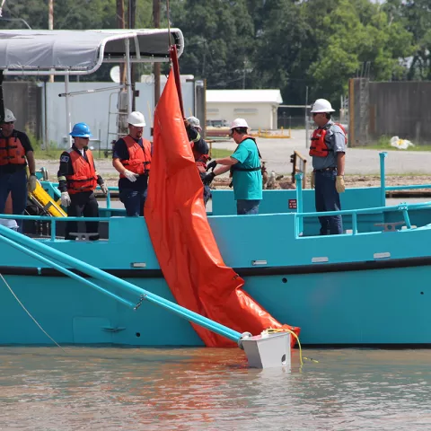 Oil spill removal organization personnel prepare to deploy an oil spill containment boom during an industry training session in the Gulf of Mexico.