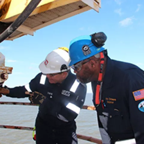 BSEE and U.S. Coast Guard inspectors jointly assess the safety of equipment aboard an offshore oil and natural gas production platform.