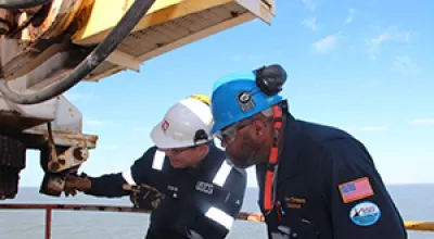 BSEE and U.S. Coast Guard inspectors jointly assess the safety of equipment aboard an offshore oil and natural gas production platform.